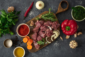 Canvas Print - Cuts beef with vegetable. kitchen table with ingredients cooking meat and veggies