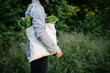 © 4Max - Man holding an eco bag filled with grocery. Vegetables and fruits. Ecology concept environment protection.