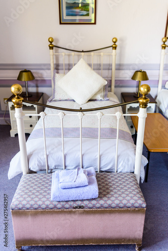 Old Fashioned Metal Single Bedstead In An Bedroom Decorated