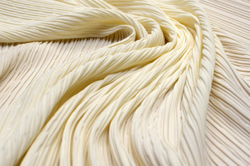 Pleated polyamide fabric. Ivory. Texture, background, pattern.