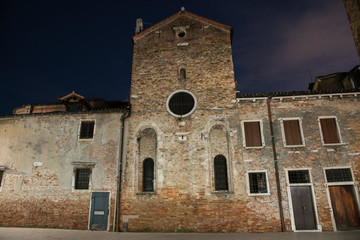 Wall Mural - Night photography of the apse of the church of San Giacomo dell'Orio in the Santa Croce district in Venice, Italy. Typical old Venetian houses.