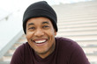 Close up cool young black man with beanie smiling