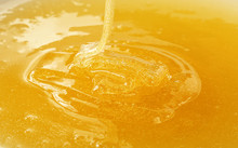 Close Up Pouring Fresh Fluid Honey In Bowl