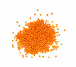 Heap of orange lentil lens isolated on white