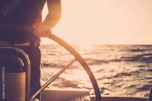 Fotomural Close up of man's hand on sail boat helm - marine ship lifestyle concept of trav