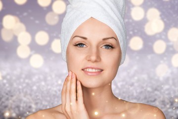 Poster - Portrait of beautiful young woman  in white towel on head on white background