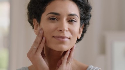 portrait beautiful young woman looking in mirror at perfect healthy skin touching face with hands en