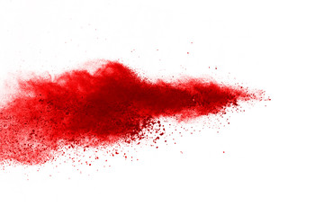 Wall Mural - freeze motion of red powder exploding, isolated on white background. abstract design of red dust clo
