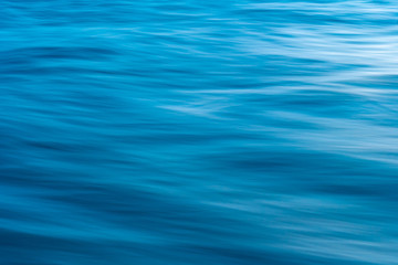 Wall Mural - Gentle soothing silky flowing natural ocean water movement. Abstract background motion blur. Serene and peaceful deep blue sea in nature.