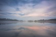 © Alex - Gorgeous view of fog on sunset on lake on summer day. White clouds on blue sky. Europe. Sweden. Gorgeous backgrounds.
