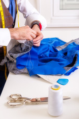 Wall Mural - Male tailor hands during suit manufacturing