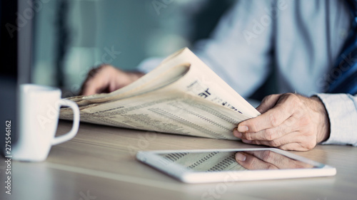 Fotografía Businessman reading the newspaper on table