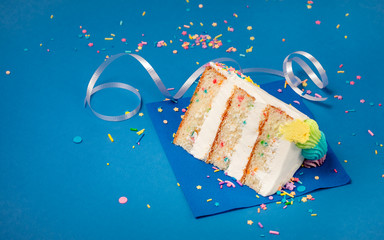 Wall Mural - Slice of Birthday Cake on blue