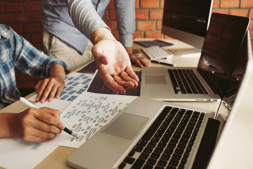 Two software developers are analyzing together about the code written into the program on the computer.