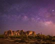 The Iconic Superstition Mountains East Of Phoenix, Arizona Glow Under The Desert Night Sky And The Epic Milky Way Our World Under Our Universe In Star Filled Dark Skies Is Natural Beauty