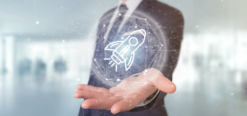 Poster - businessman holding a start up rocket on a sphere 3d rendering