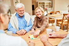Group Of Seniors Enjoys Board Game