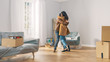 Excited Young Couple Look Around In Wonder at their Newly Purchased / Rented Apartment. Beautiful People Happily Embracing. Bright Modern Home for Happy Young People.