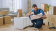 © Gorodenkoff - Successful Furniture Assembly Worker Reads Instructions to Assemble Shelf. Professional Handyman Doing Assembly Job Well, Helping People who Move into New House.