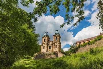 Skoky, Zlutice / Czech Republic - June 21 2019: Baroque church of the Virgin Mary Visitation in Skoky, Maria Stock, is a former pilgrimage place in West Bohemia. Sunny day, blue sky with clouds.