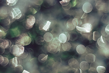 Poster - Beautiful light bokeh on a green background.