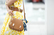 Women accessories closeup picture. Purse, sunglasses and the .kerchief. Brown handbag with fashion details.