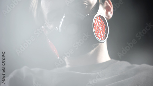 Man Wearing Respirator Sleeping In Room Full Of Smoke