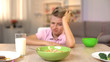 © motortion - Unhappy boy looking oatmeal with disgust, unappetizing food, healthy breakfast