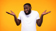 © motortion - Confused afro-american man showing no idea gesture, problem hesitation, choice