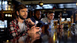 © motortion - Nervous fans checking bets on smartphone, watching game in bar, bookmaker app