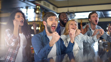Extremely Happy Sport Fans Actively Cheering Team, Celebrating Victory In Bar
