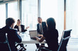 © BullRun - Male and female colleagues sitting in office cooperating and discussing ideas using laptop computer, employees share creative strategies for startup brainstorming together on business meeting