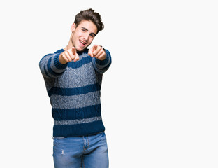 Young handsome man over isolated background Pointing to you and the camera with fingers, smiling positive and cheerful