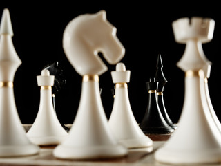 chess pieces on the board on a black background