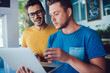 © BullRun - Positive hipster guys browsing website connected to 4g wireless internet on laptop computer for online work, happy male programmers using modern digital technology for online communication