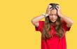 © Krakenimages.com - Young beautiful brunette woman wearing red t-shirt over isolated background suffering from headache desperate and stressed because pain and migraine. Hands on head.