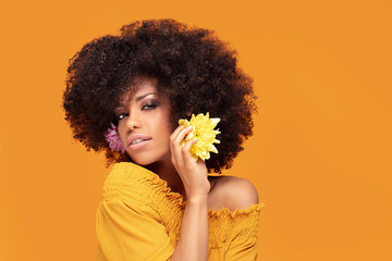 Wall Mural - Beauty afro woman with fresh flowers.