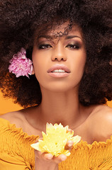 Wall Mural - Beauty afro woman with fresh flowers.