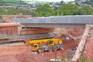 Wall Mural - Mobile crane by a bridge under construction