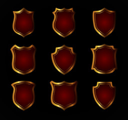 Gold shield shape icons set. 3D golden emblem signs isolated on black background. Symbol of security, power, protection. Badge shape shield graphic design illustration eps10