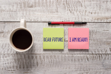 Wall Mural - Text sign showing Dear Future I Am Ready. Business photo text state action situation being fully prepared Stationary placed next to a cup of black coffee above the wooden table