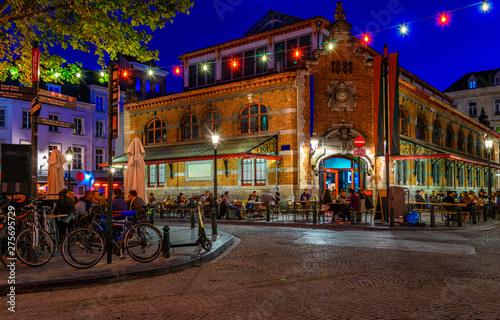 Old street with tables of cafe in center of Brussels, Belgium. Night cityscap...