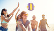 © alphaspirit - Group of friends playing at beach volley at the beach