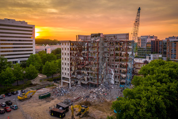 Aerial view of an office building under demolition by a wrecking ball in Columbia Town Center  Maryland new Washington DC 