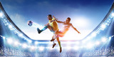 Fototapeta Sport - Soccer players on stadium in action. Mixed media