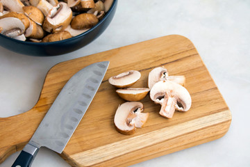 Wall Mural - Slicing Cremini Mushrooms on a Wood Cutting Board