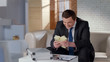 © motortion - Excited greedy businessman holding big money, celebrating profitable startup