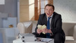 © motortion - Overjoyed businessman holding big money, celebrating profitable startup, lottery