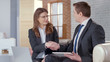 © motortion - Male and female business partners come to successful agreement, shaking hands
