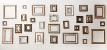 Multiple Many Blank Small Picture Frames On White Wall
